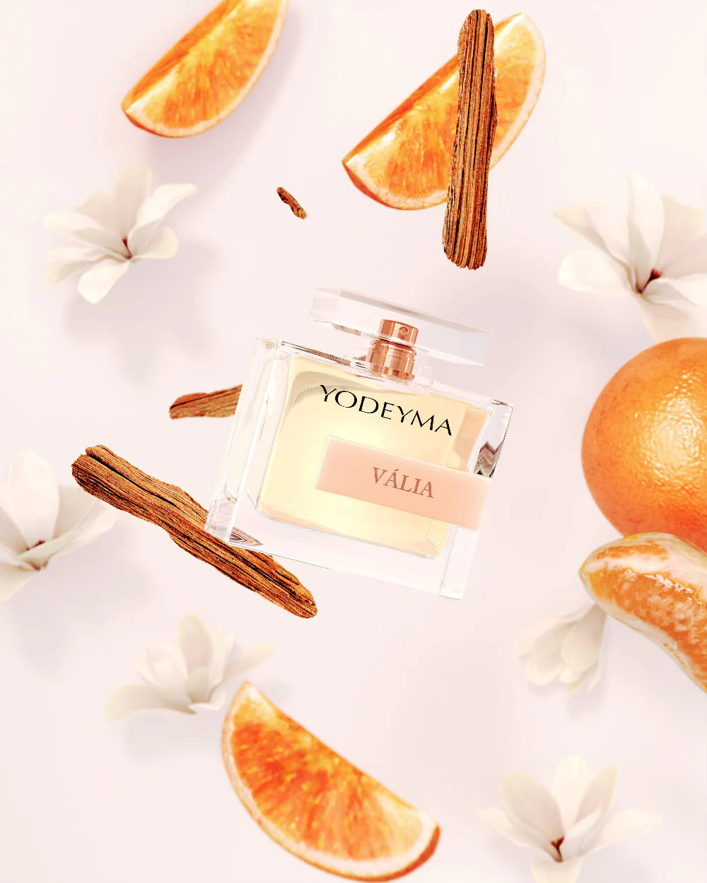 YODEYMA Valia perfume bottle surrounded by orange slices and cinnamon sticks on a light background